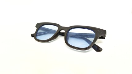 blue lensed sun glasses on a white background