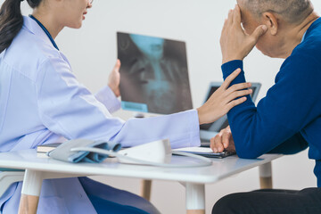 Obraz premium Asian people experienced female doctor giving advice to elderly male patient cancer and x-ray results and treatment options, Cancer Consultation, Elderly Man Receives Expert Cancer Advice Awareness
