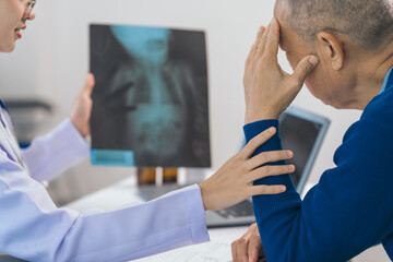 Fototapeta premium Asian people experienced female doctor giving advice to elderly male patient cancer and x-ray results and treatment options, Cancer Consultation, Elderly Man Receives Expert Cancer Advice Awareness
