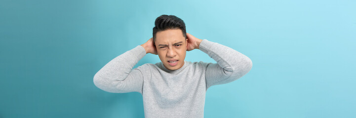 Banner of man holding head with both hands angry and screaming being stressed