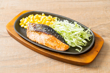 grilled salmon fillet steak on hot plate
