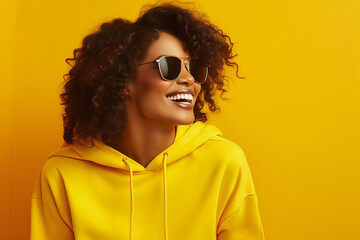 Beautiful young black female in yellow sporty clothes on a bright yellow background