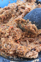 Peanut sauce mashed with a mortar and pestle on the table