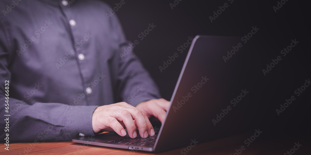 Poster man entrepreneur use laptop computer working at night. male hands typing on the laptop keyboard. bus