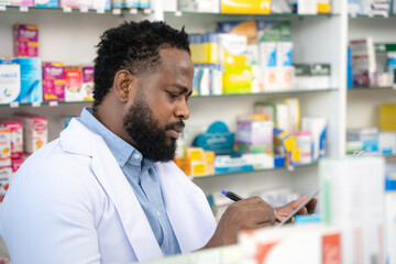 Male pharmacist working at pharmacy store. Pharmacy, Medical, Healthcare, Lifestyle and Science concept.