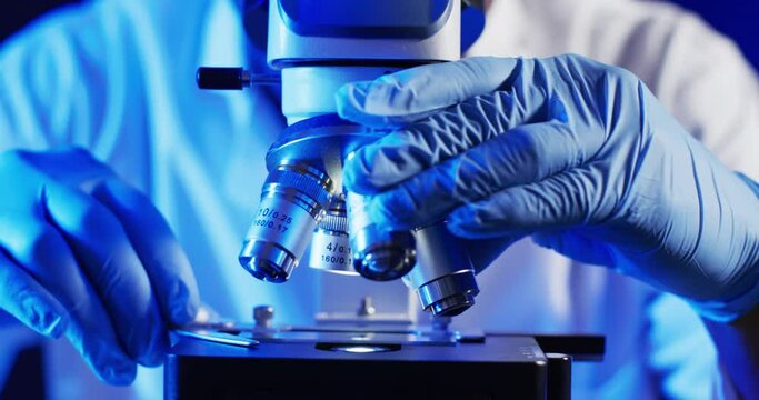 Video of close up of male scientist using laboratory microscope with copy space on white background - Powered by Adobe