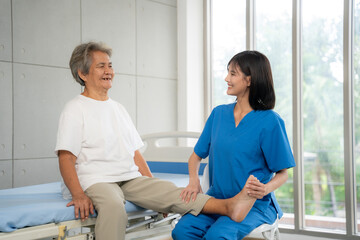 Nurse helps senior woman do physical therapy at the hospital. Healthcare, Retirement, Volunteer, Caregiver and Lifestyle concept.