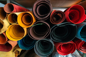 Colorful raw genuine vegetable tanned leather on shelf in crafts shop