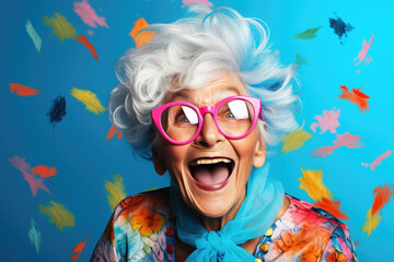 cheerful and funny happy old woman in vivid shine blue background