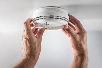 Fotobehang Home smoke and fire alarm detector installing, checking, testing or replace battery © Brian Jackson
