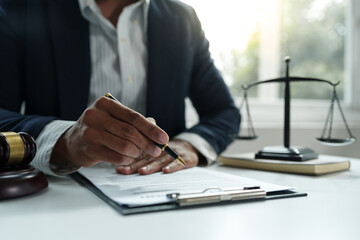 Young lawyer or legal advisor is reading and carefully checking the validity of documents and investment agreements for signing contracts managing justice concepts.