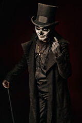 Baron Samedi, the Voodoo deity. Baron Saturday in black coat and top hat with stick in hand. Day of...