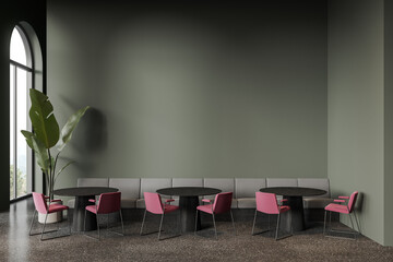 Green cafe interior with couch and blank wall