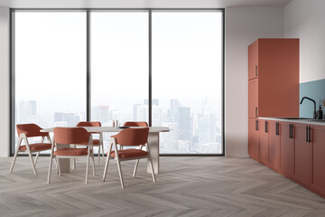 White and pink kitchen with cabinets and dining table