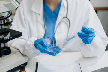 female scientist working with micro pipettes analyzing biochemical samples, advanced science...