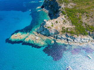 Aerial view of Corsica's step coastline and a lighthouse, Island, Mediterranean, France - 654720282