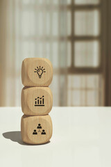 Conceptual business illustration with wooden cubes and icons business growth strategy and target
