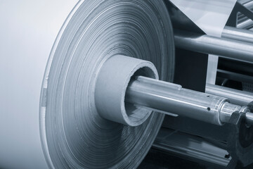 Rolls paper and fabric in wide industrial plotter