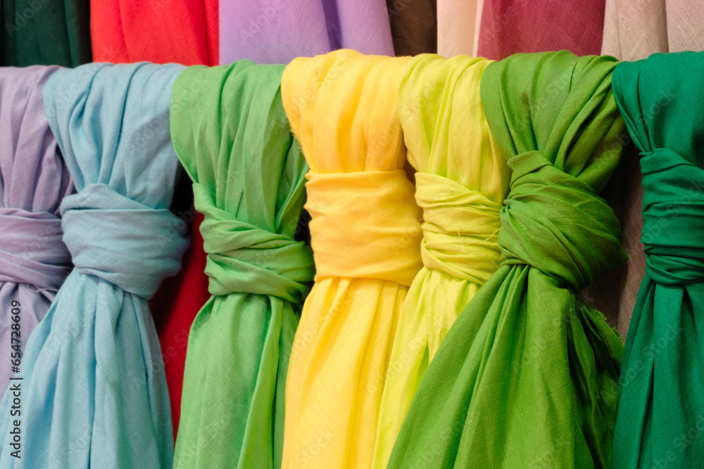 Poster mix colorful hanging vertical stripe textile, fabrics, cloths on the rack. texture of multicolored f