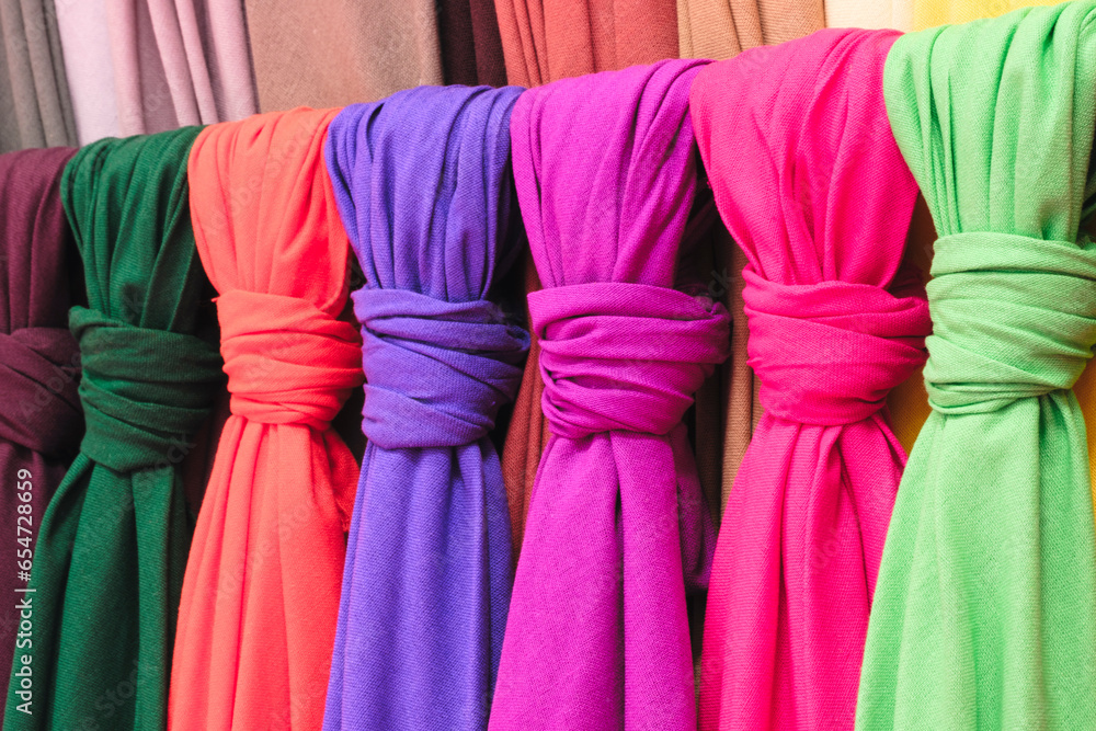 Poster mix colorful hanging vertical stripe textile, fabrics, cloths on the rack. texture of multicolored f