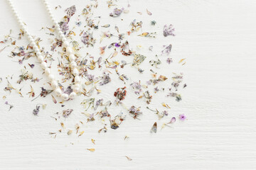 Background of dry delicate flowers and pearls