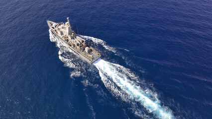 Aerial drone photo of armed navy frigate cruising deep blue sea