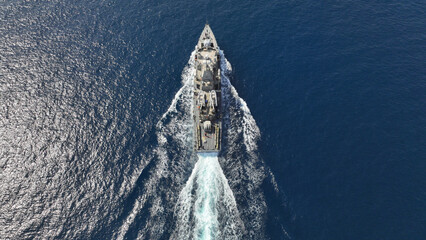 Aerial drone photo of armed navy frigate cruising deep blue sea