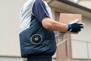 荷物を運ぶ40代配達員