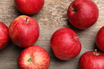 Fresh red apples on wooden table, flat lay