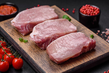 Raw fresh pork meat steak with salt, spices and herbs