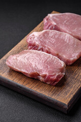 Raw fresh pork meat steak with salt, spices and herbs