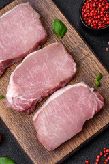Raw fresh pork meat steak with salt, spices and herbs
