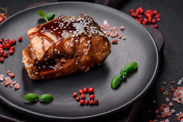 Delicious grilled salmon fillet with salt, spices, herbs and sauce