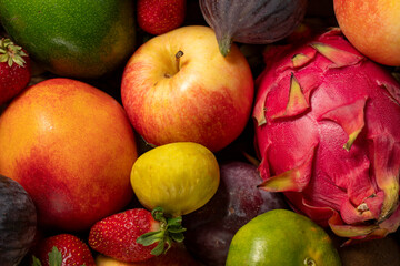 Close-up fresh colorful fruits background. Mixed fruit. Close-up. Grape, Fig, Strawberry, apple,...