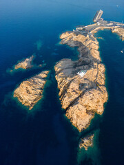 Aerial view of La Pietra lighthouse and island at Ile Rousse in Corsica - 654747820