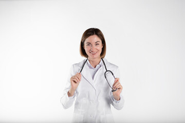 Portrait of young cheerful female doctor with stethoscope isolated on white background