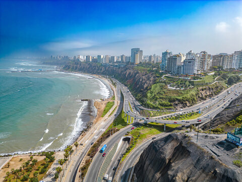 Aerial image of Mirador Arturo Polanco with luxury houses on the stone hillside, large avenue Bajada de Armendariz and Playa La Estrella in the background.