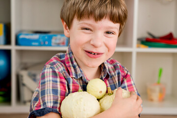 Fototapeta premium Harvest festival. Happy boy with decorative pumpkins from his own garden. Basics of horticulture in kindergarten. 