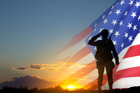 Silhouette of soldier with USA flag against the sunset. Greeting card for Veterans Day, Memorial Day, Independence Day