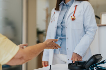 Elderly female patient telling health problems to her doctor.