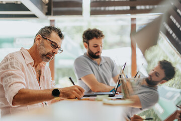 Successful professionals in diverse team work together in an office, sharing ideas and optimizing their marketing strategies for customer engagement.