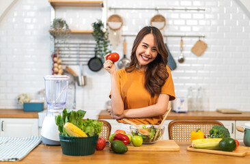 Portrait of beauty body slim healthy asian woman having fun cooking and preparing cooking vegan food healthy eat with fresh vegetable salad on counter in kitchen at home.Diet concept.Fitness, healthy 