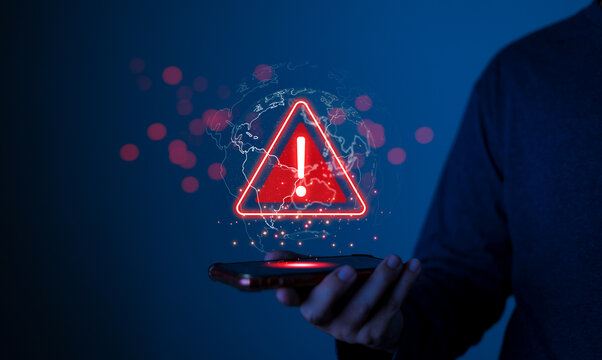 hacker attack maintenance concept and hacking cybercrime cyber security User is using smartphone with warning triangle for error notification.