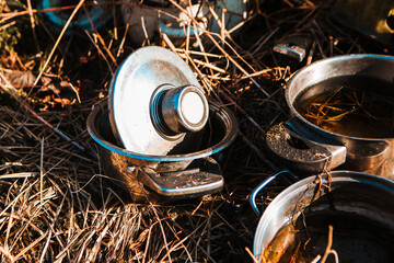 Old rusty pots on the grass. Things out of use concept