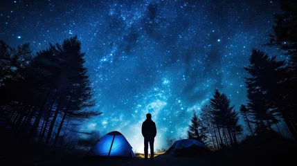 Papier Peint photo Camping Night sky with stars and a silhouette of a standing happy man with blue light. Space background - travel people concept - free camping and outdoor adventure - discover the world lifestyle