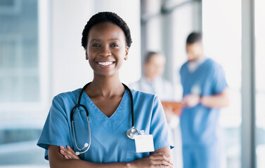 Smile, nurse and portrait of black woman with arms crossed in hospital for healthcare, wellness and nursing career. Face of happy African surgeon, confident medical professional worker and employee - obrazy, fototapety, plakaty