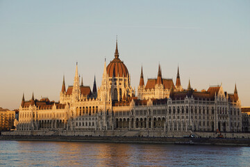 Hungarian parliament building in Budapest with river Danube - sunset golden hour