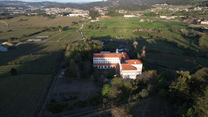 Aerial view of the Monastery of Saint Scholastica, in Roriz, in the municipality of Santo Tirso. A nuns convent famous for its butter cookies (cloister delicacies). - obrazy, fototapety, plakaty