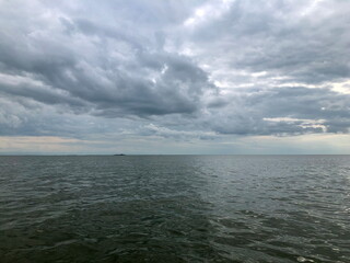 Dramatic seascape low dark clouds over the sea