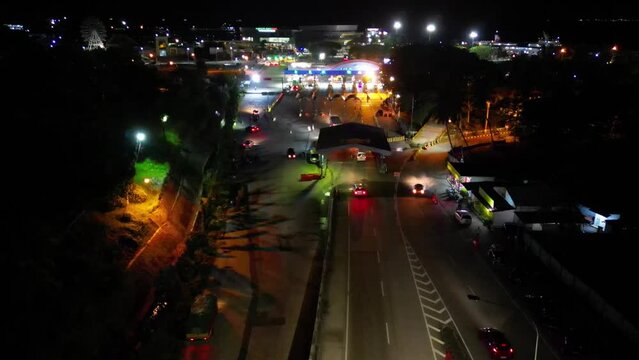 The DRON camera moves over the entrance to the port, a nighttime scene.